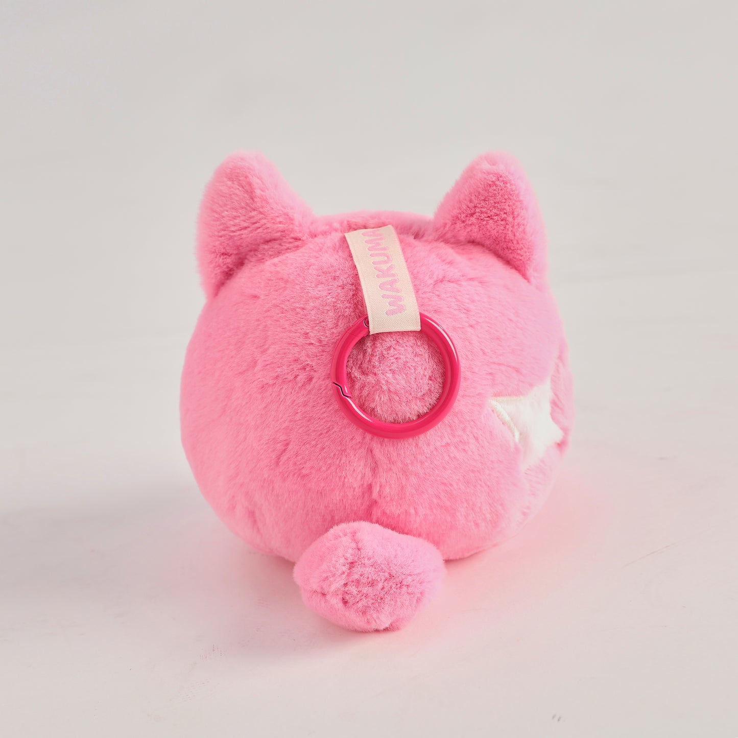 Pink round Wakuma bear plush keychain with chibi-style face, two forehead marks, and small paws. Back View.