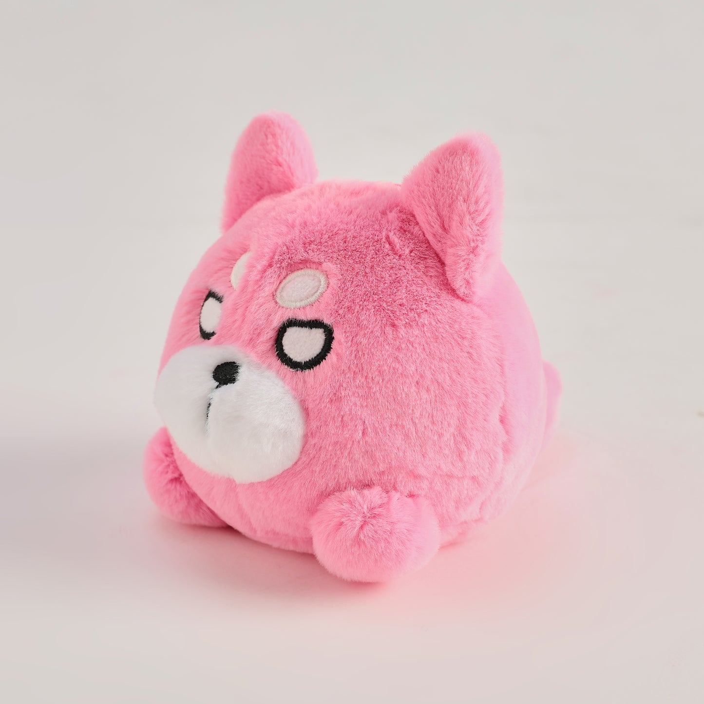 Pink round Wakuma bear plush keychain with chibi-style face, two forehead marks, and small paws.