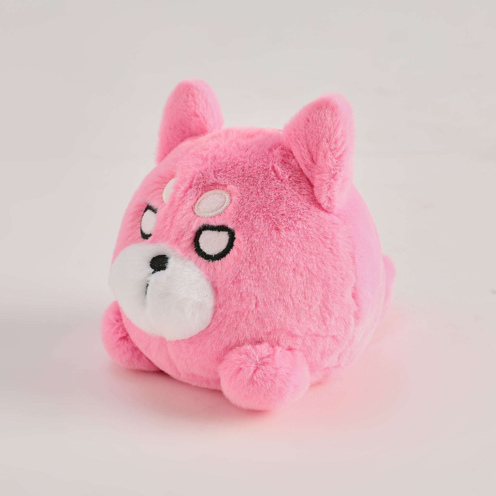 Pink round Wakuma bear plush keychain with chibi-style face, two forehead marks, and small paws.